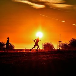 Silhouette of people at sunset