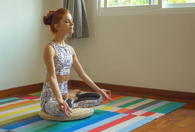 Woman sitting on floor at home