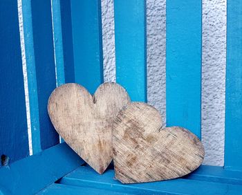 Close-up of heart shape woods on blue bench