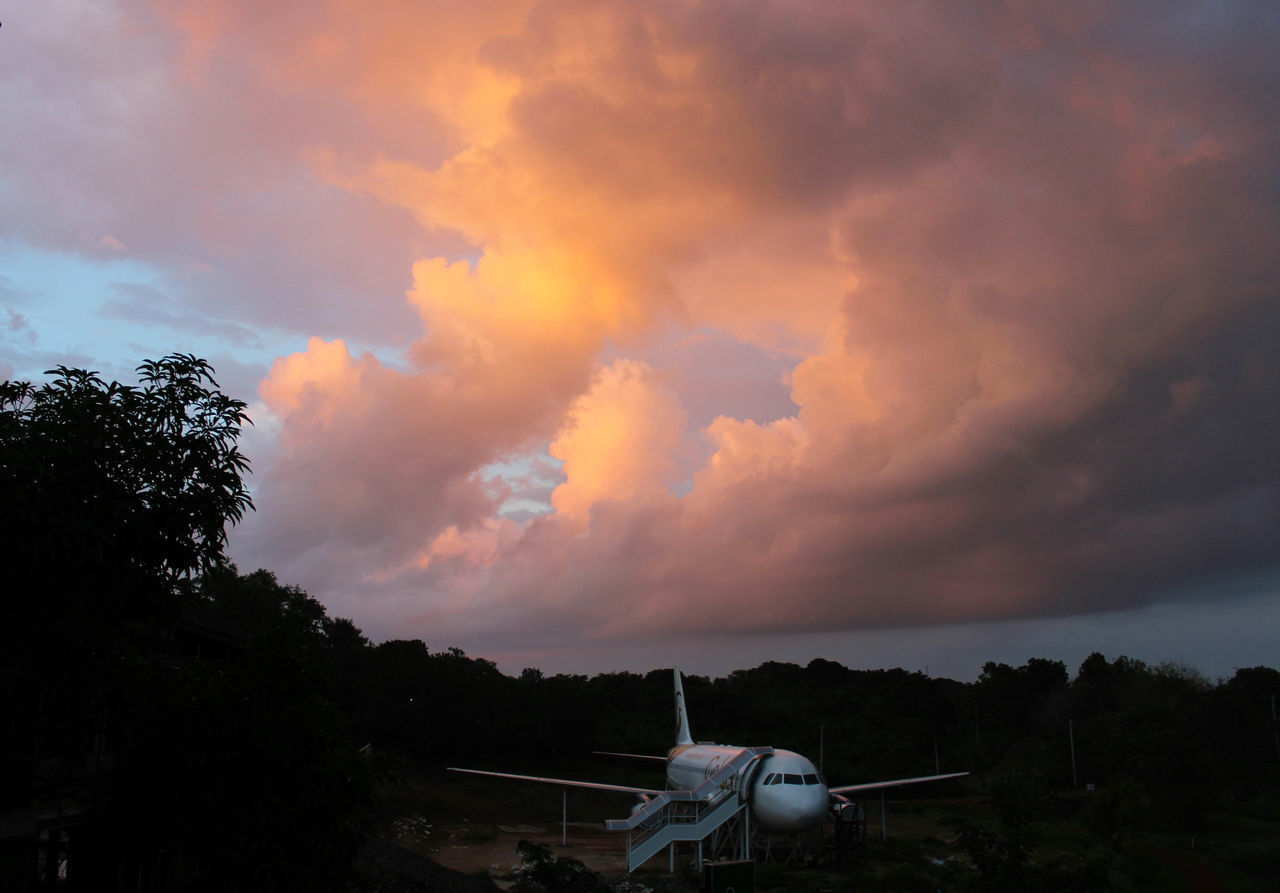 AIRPLANE AGAINST SKY AT SUNSET