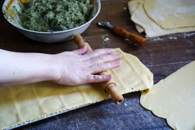 Close-up of woman preparing food on cutting board