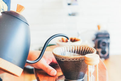 Close-up of hand holding coffee cup