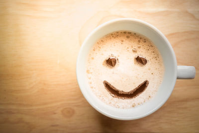 Directly above shot of cappuccino served on table