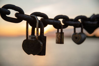 Close-up of padlock on chain against sky