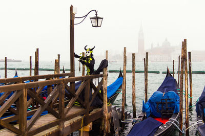 Panoramic view of wooden post in sea against sky