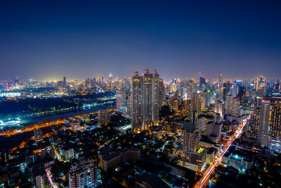 High angle view of illuminated city buildings against sky