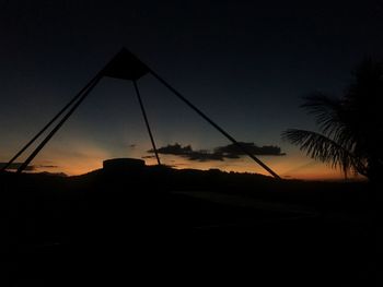 Silhouette trees against sky at dusk