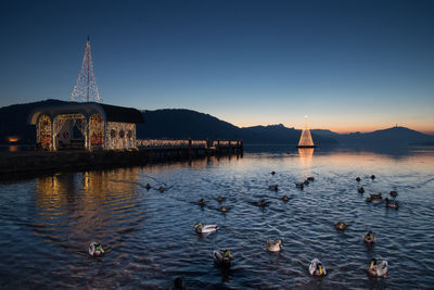 Scenic view of lake by buildings against sky