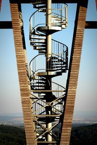 Metallic spiral staircase at rozhledna salas against sky