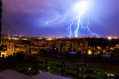 Forked lightning over illuminated city