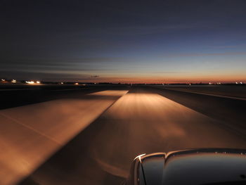 Illuminated road seen through airplane window at night