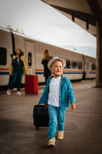 Portrait of boy standing on bus