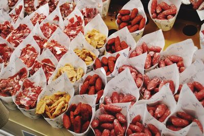 High angle view of food wrapped in papers for sale at market stall