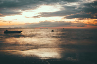 Scenic view of sea against cloudy sky