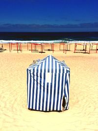 Scenic view of beach against blue sky