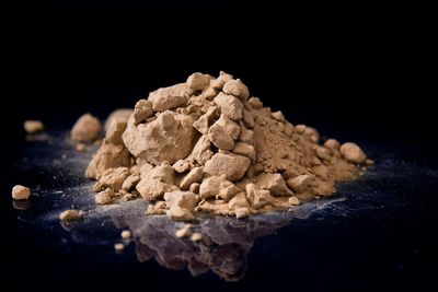 Close-up of stack on rock against black background