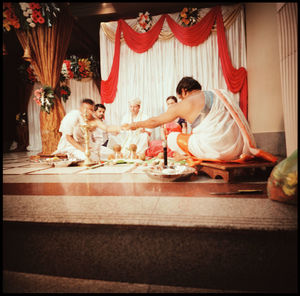 Side view of couple sitting on table