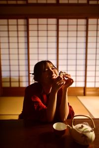 Young woman sitting at home