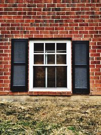 Red window on brick wall