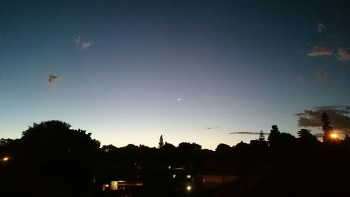 Silhouette of building against sky at dusk