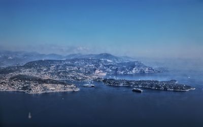 Aerial view of sea against blue sky