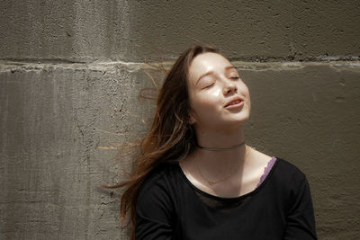 Close-up of beautiful young woman with eyes closed