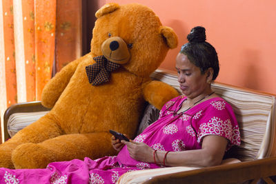 Rear view of woman using mobile phone