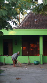 Side view of man working on building