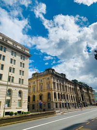 Low angle view of building against cloudy sky