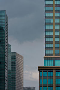 Low angle view of modern buildings in city against sky