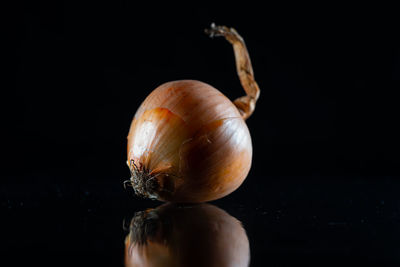 Close-up of apple on table against black background