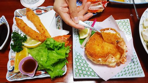 Close-up of man holding food in plate