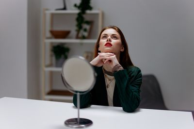 Portrait of young woman sitting at home