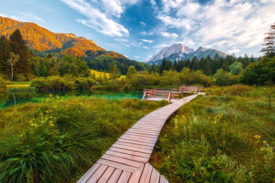 Scenic view of lake by mountains against sky