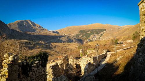 Scenic view of mountains against blue sky. abruzzo apennines.medieval village of aielli, aq italy.