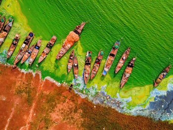 Aerial view of fishing boat moored at harbor