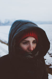 Close-up portrait of young woman in winter
