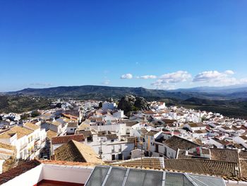 High angle view of town against blue sky