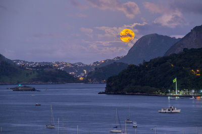 Scenic view of sea and mountains against sky