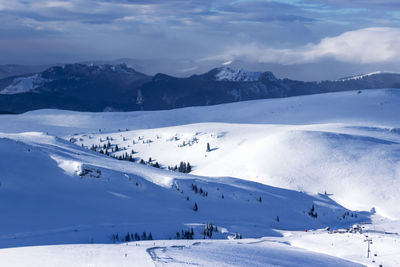 Scenic view of snow covered mountains against sky