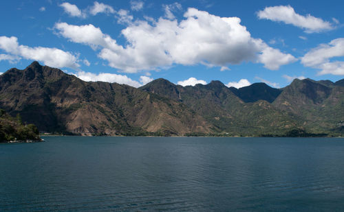 Scenic view of sea and mountains against sky