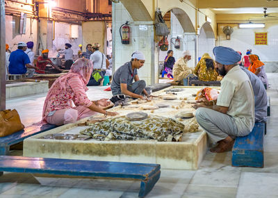 Group of people working at market