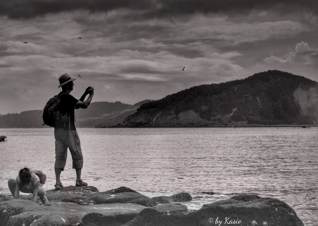 sky, mountain, water, sea, cloud - sky, mountain range, full length, scenics, animal themes, tranquil scene, cloud, beauty in nature, men, nature, silhouette, tranquility, bird, leisure activity