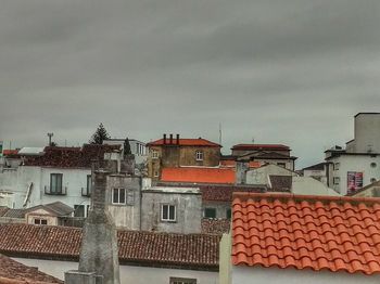 Houses against cloudy sky