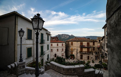 Buildings in town against sky