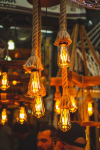 Illuminated light bulbs hanging from ceiling