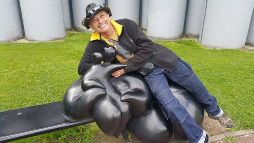 Portrait of smiling man sitting on grass