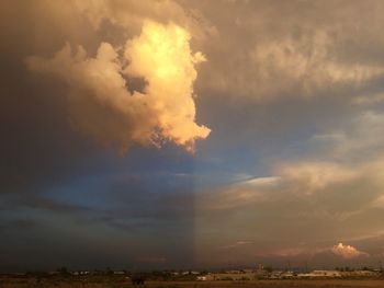 Scenic view of landscape against cloudy sky