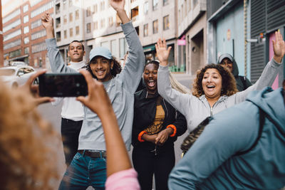 Group of people photographing in city