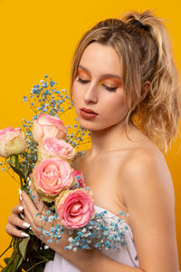 Portrait of woman with pink roses